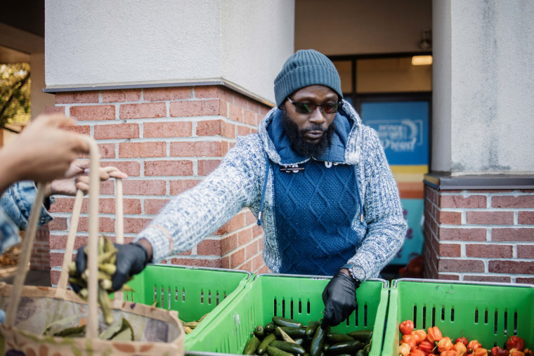 At the No Limits Outreach food pantry, volunteer Kesu helps distribute fresh produce to federal workers who had been furloughed because of the government shutdown.