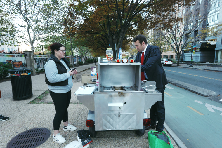 Isaac Stein's last customer of the day waits in line for a Shysters dog.