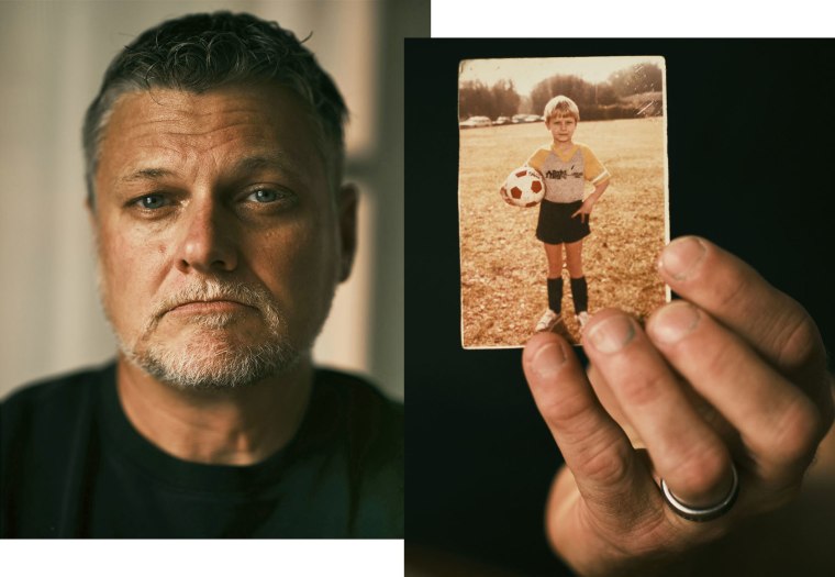 Chris Woods Sr. holds up a photo of himself from 1984