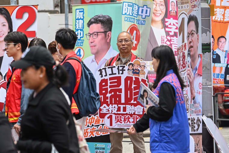 Supporters campaign for their candidates Sunday in the Legislative Council elections in Wanchai district of Hong Kong.