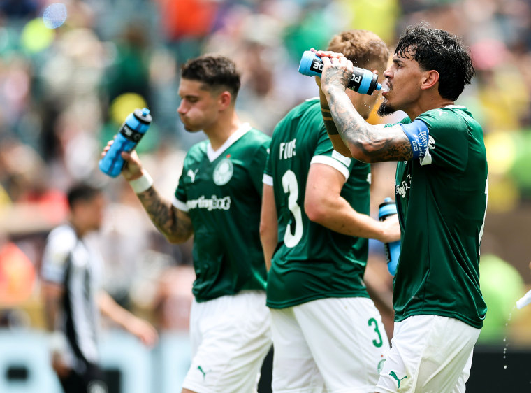 Gustavo Gomez drinks from a Powerade bottle near his teammates