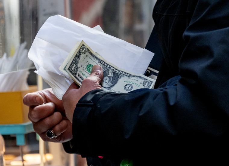 A shopper pays for food with cash in the Ferry Building in San Francisco, Calif. on Dec. 4.
