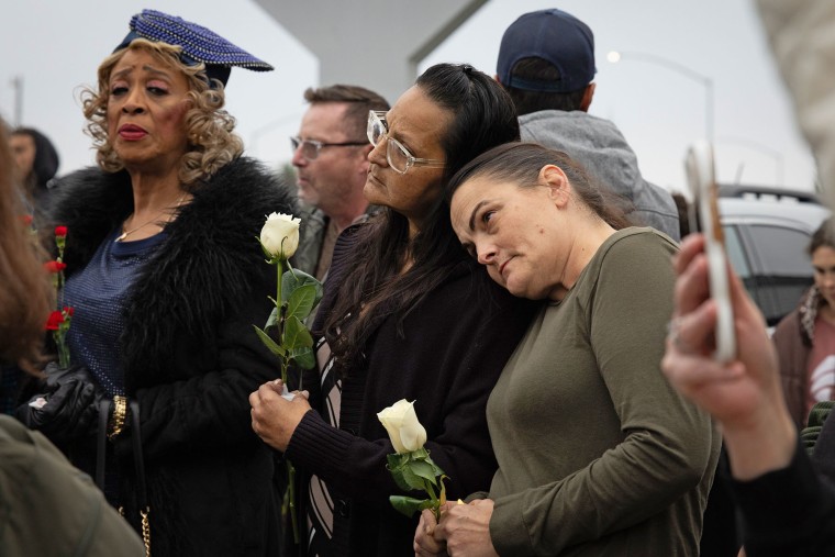 People lean on each other at a vigil on Nov. 30, 2025 in Stockton, Calif., for the victims of a shooting at a family party.