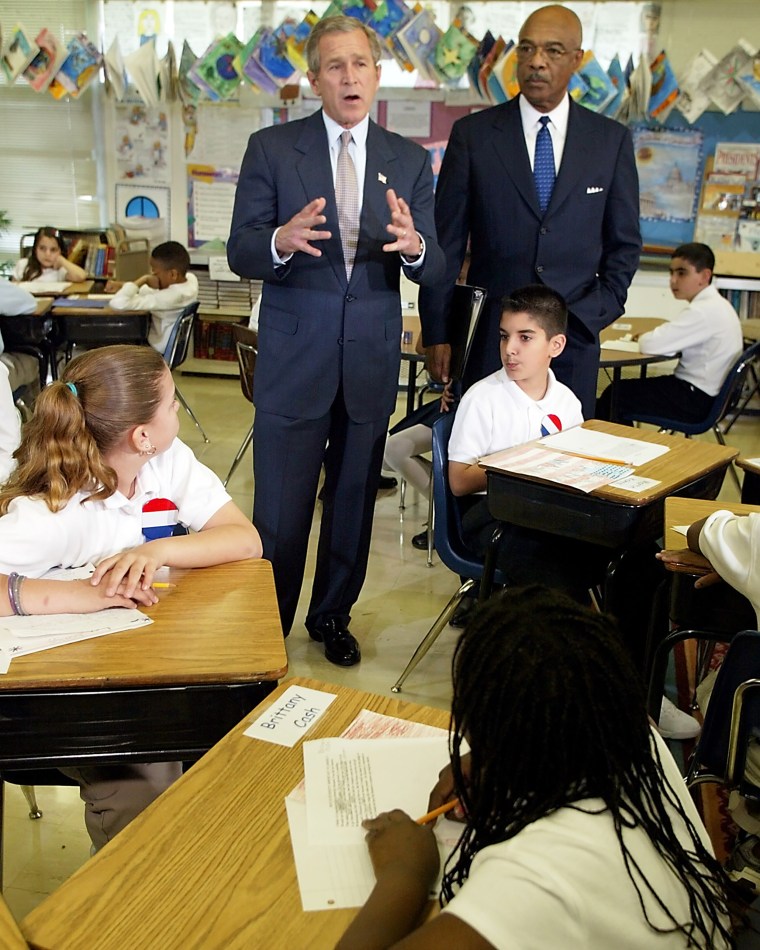 US President George W. Bush (L) with Secretary of