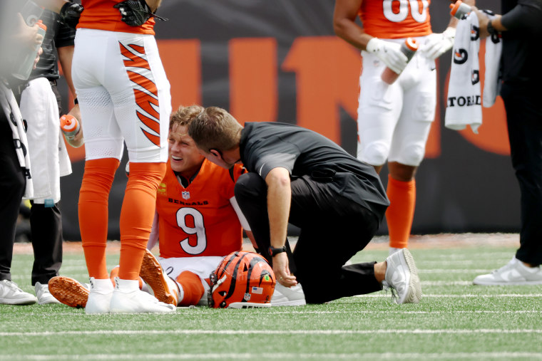 Joe Burrow of the Cincinnati Bengals is looked at by staff following an injury in the second quarter of the game against the Jacksonville Jaguars at Paycor Stadium on September 14 in Cincinnati, Ohio.