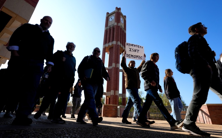Marches pass by the clock tower at the Bizzell Memorial Library during a protest and march supporting the graduate assistant that graded Samantha Fulnecky's essay