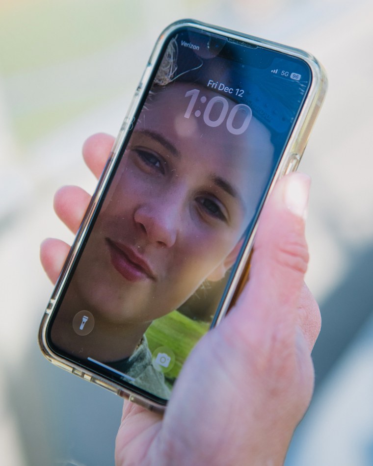 Tricia Maciejewski holds her phone with a photo of his son as screensave.