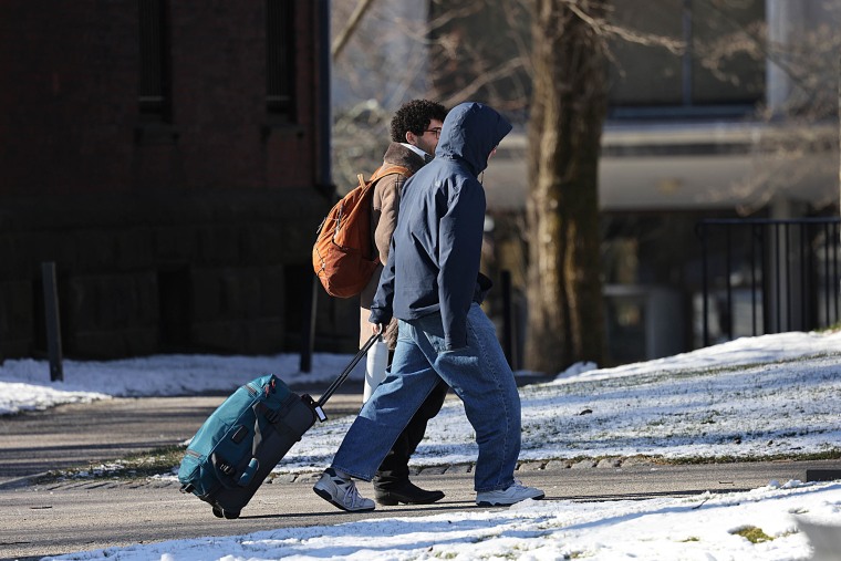 Students leave the campus of Brown University two days after a mass shooting on December 15, 2025.