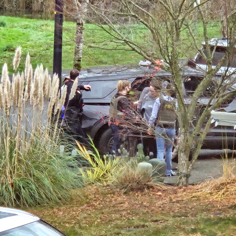 Law enforcement activity outside Megan Hall-Greenberg’s home in Washougal, Wash.
