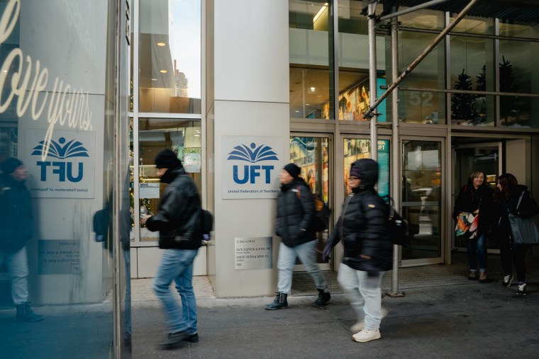 People walk past the building for the United Federation of Teachers