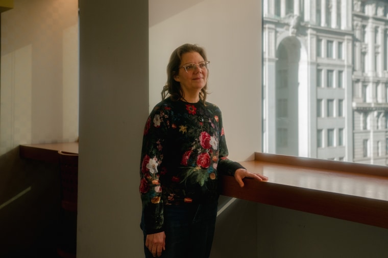 Jennifer Goodnow stands by a window