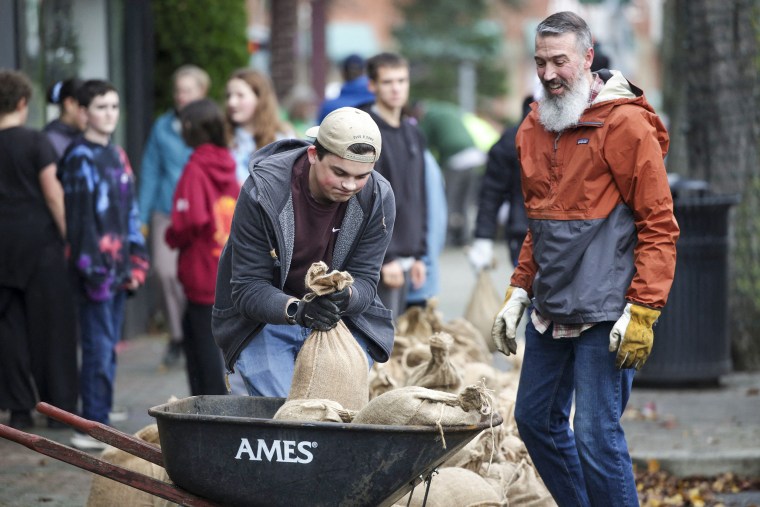 Neighborhood volunteers help fill sandbags for downtown businesses along the Skagit River in Mount Vernon, Washington