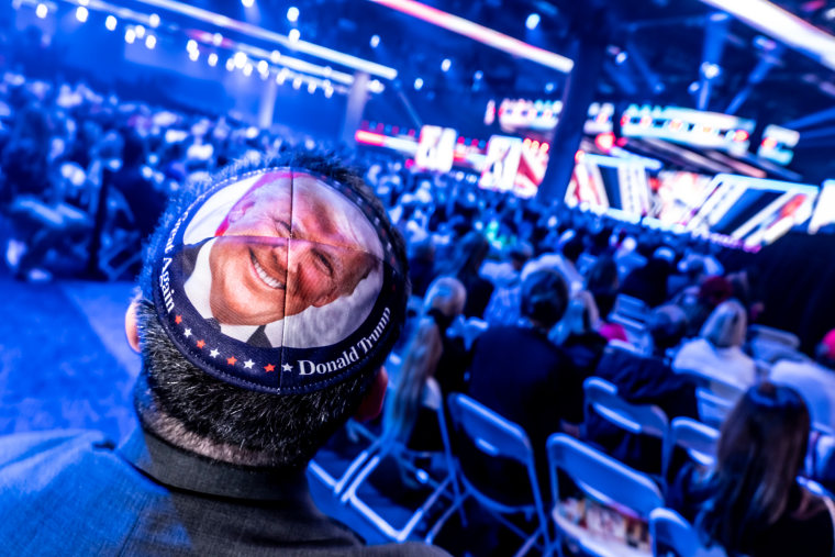 A yarmulke on the back of a person's head with Donald Trump's face on it