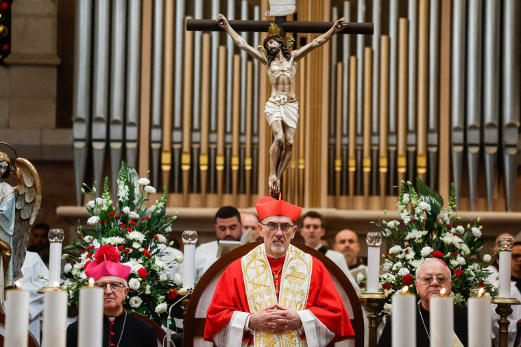 Pierbattista Pizzaballa sits inside of a church