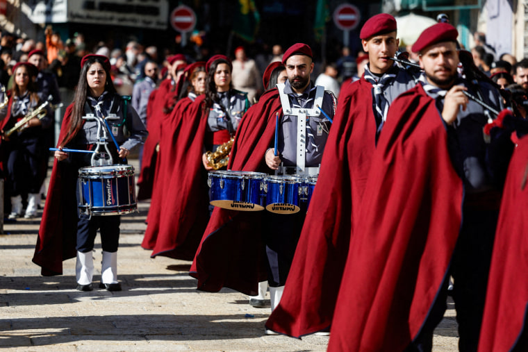 Palestinian scouts parade at Manger Square outside the Church of the Nativity in Bethlehem
