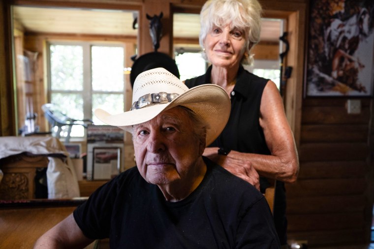 Ben Nighthorse Campbell sits as Linda Campbell stands behind him