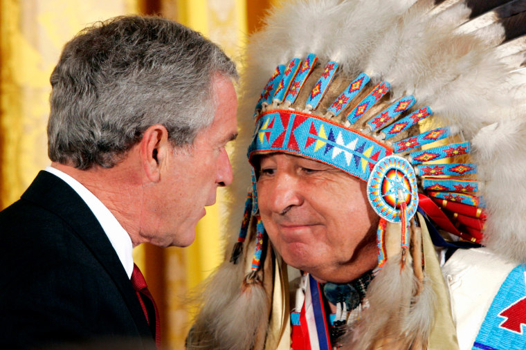 George W. Bush, left, and Ben Nighthorse Campbell, wearing a Native American headdress