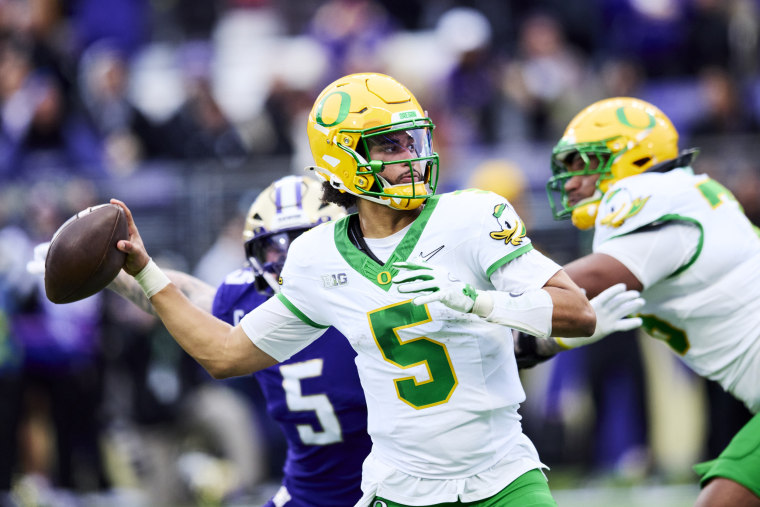 Oregon quarterback Dante Moore throws a pass against the Washington Huskies in Seattle on Nov. 29.