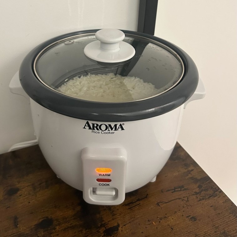 Aroma rice cooker on top of dark wood counter