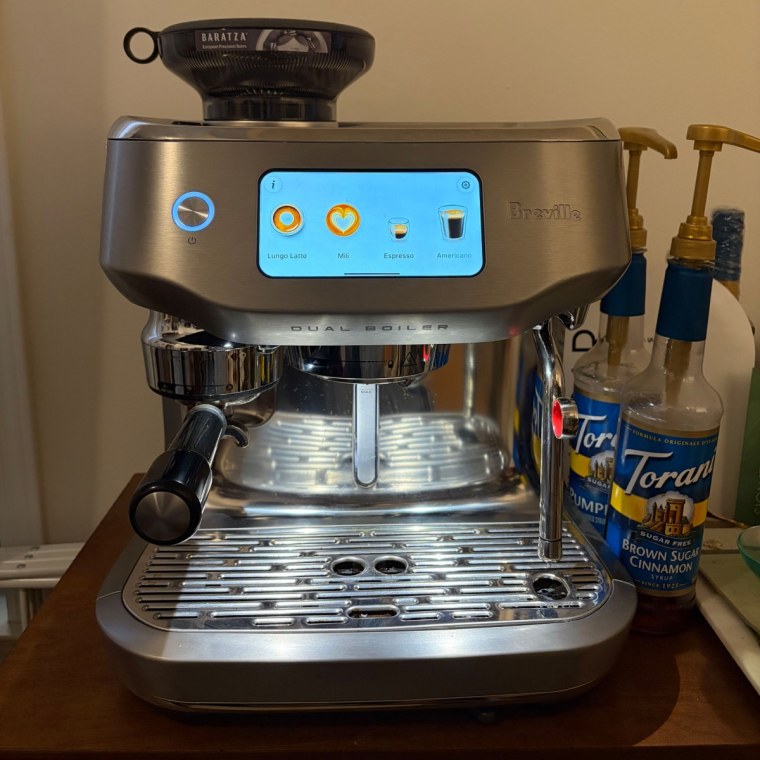 Espresso machine on dark wood counter