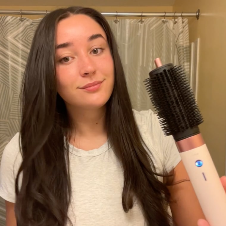 Woman using Dyson Airwrap to style her hair