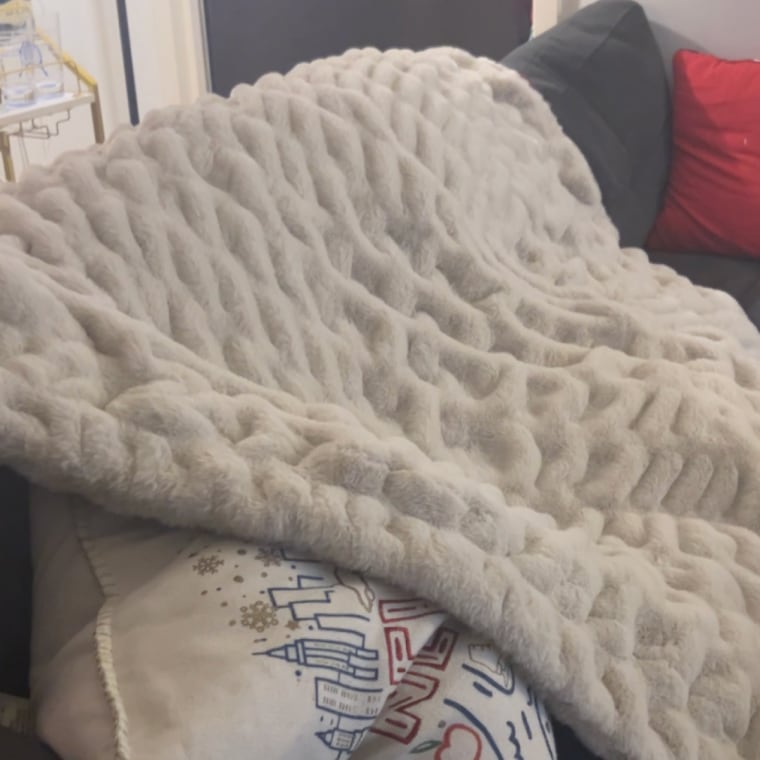 Blanket laying on back of couch