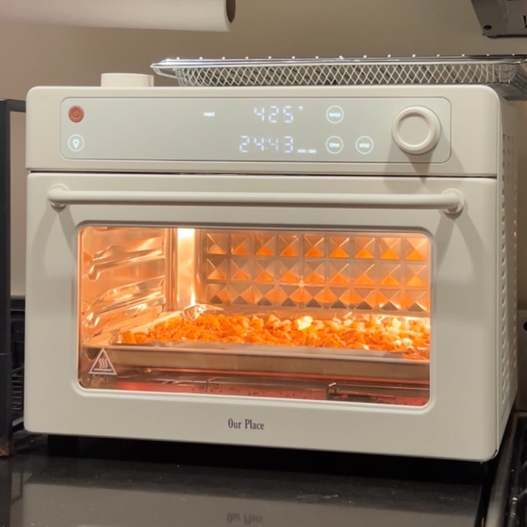 Our Place Wonder Oven baking food on kitchen counter