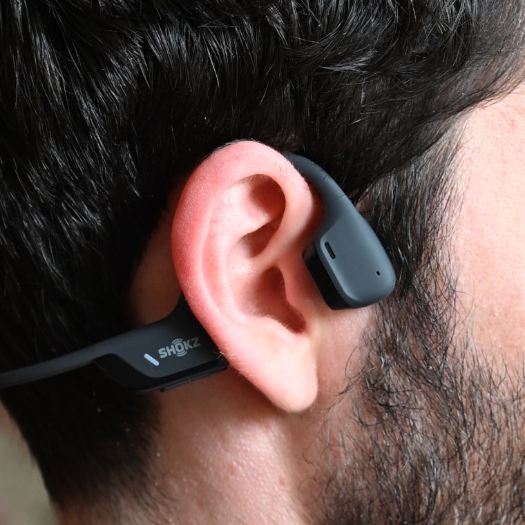 A close up of a Shokz OpenRun Pro 2 headphones on the ear of the writer.