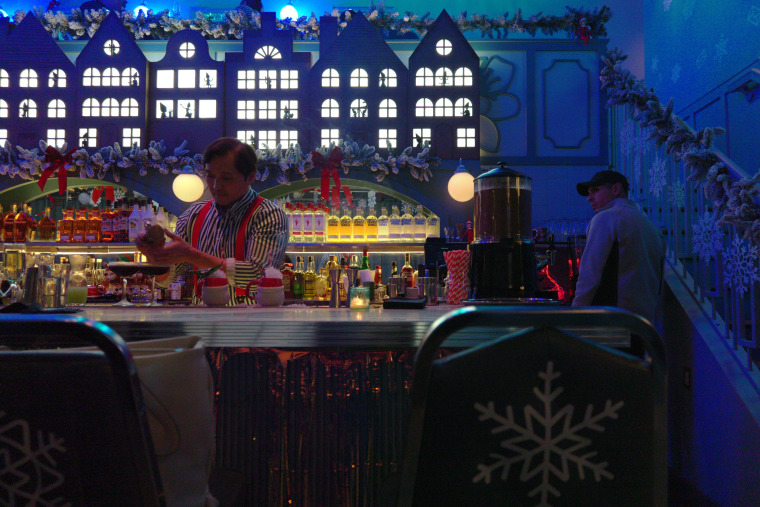 Assistant General Manager Rhine Dizon mixes a cocktail at the Cheers from the Shelf pop-up bar in Washington, D.C.
