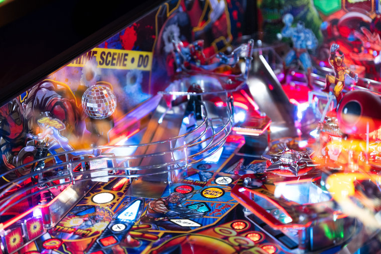 Players liken pinball to a video game. The goal of "Deadpool," for example, is to defeat villains like Mystique and complete quests.