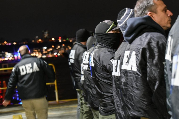 DEA agents stand in a line outside
