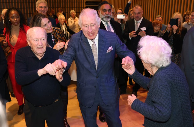 King Charles III dances with Holocaust survivor Eva Schloss, right, during a visit to the JW3 Jewish community center in London in 2022.