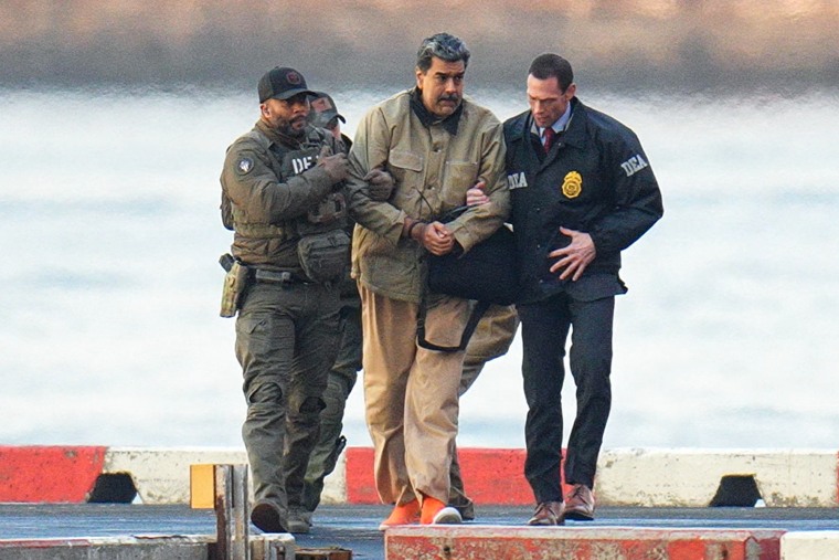 U.S. launches operation to seize Russia-flagged oil tanker linked to Venezuela插图1 Nicolas Maduro, with zip-tied wrists, is escorted by DEA agents outside