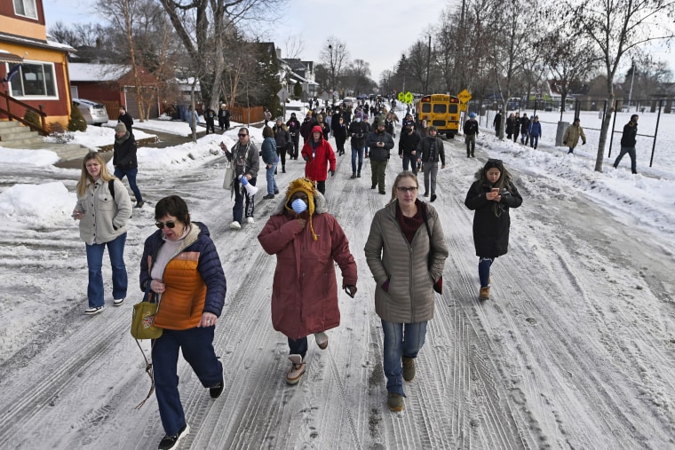 People gather near the scene of a suspected shooting by an ICE agent during federal law enforcement operations on Jan. 7, 2026 in Minneapolis, Minnesota. 