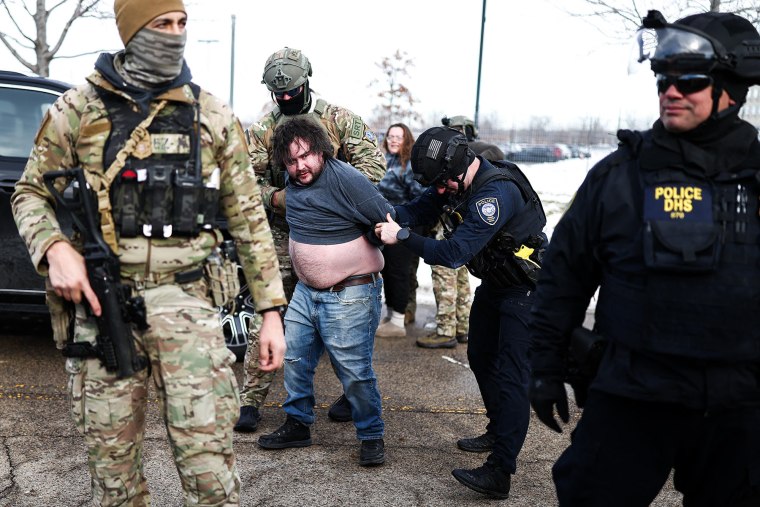 Federal agents detain a protester near the Bishop Henry Whipple Federal Building in Minneapolis, Minnesota, on January 9, 2026. 