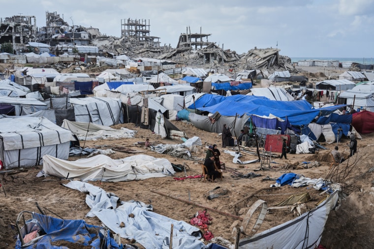A wide view of a camp of destroyed tents outside