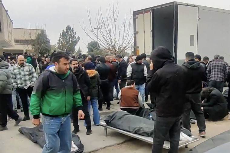 Video obtained by NBC News shows body bags outside a medical facility in Tehran province.