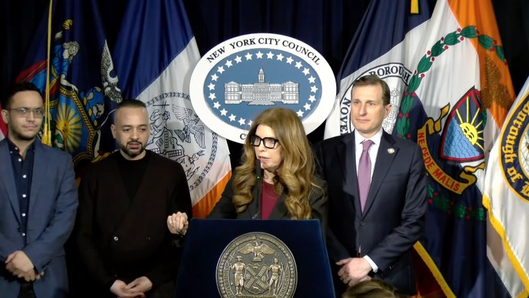 Julie Menin speaks at a podium