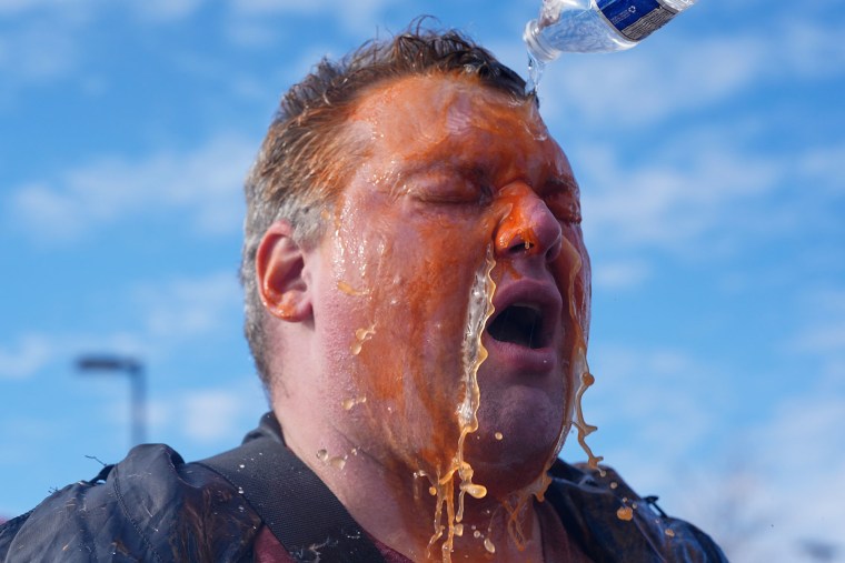 A protester's face is doused in water after he was pepper-sprayed outside of the Bishop Whipple Federal Building, Monday, Jan. 12, 2026, in Minneapolis. 