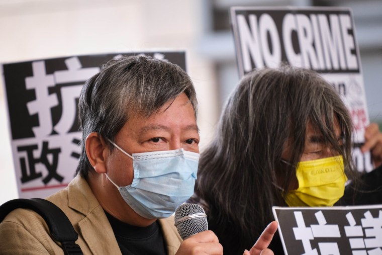 Activist Lee Cheuk-yan, wearing a face mask, speaks to the media after a court hearing at West Kowloon Magistrates Court in 2020.