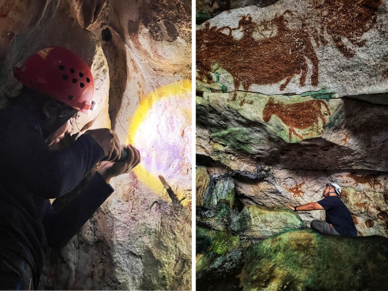 Indonesian scientists Adhi Agus Oktaviana, left, and Shinatria Adhityatama studying handprints on the walls of the cave.