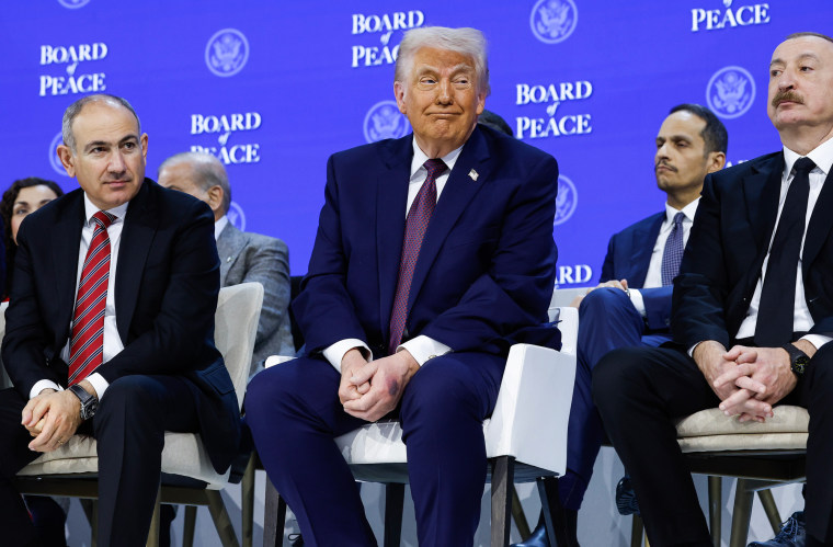 Donald Trump, center, sits in between Nikol Pashinyan, left, and Ilham Aliyev, right