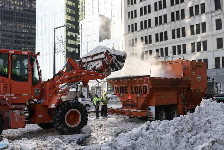 A front end loader dumps snow into a snow melter in New York on Jan. 29, 2026.