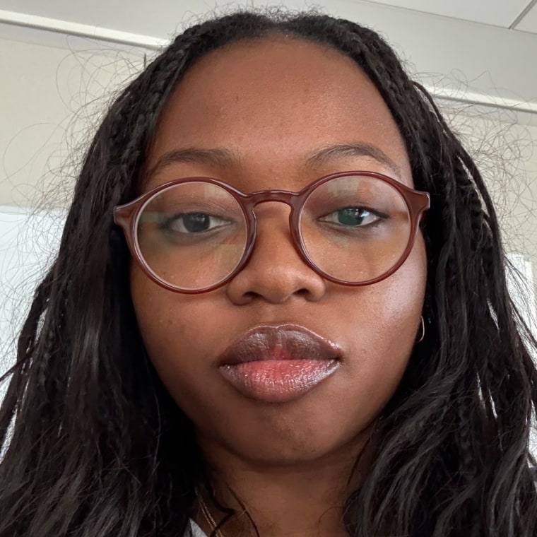 Woman applies silver tube of tinted lip balm