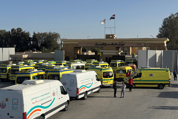 Ambulances wait on the Egyptian side of the Rafah border crossing Sunday.