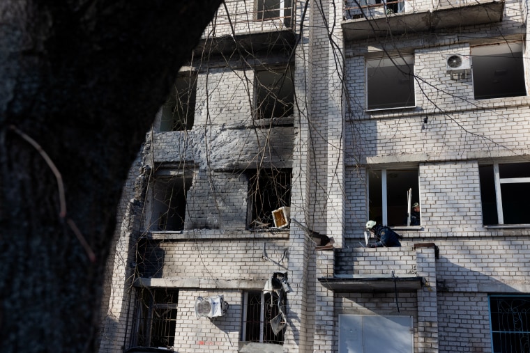A rescue worker clears debris in a damaged maternity hospital Sunday following a Russian strike in Zaporizhzhia.