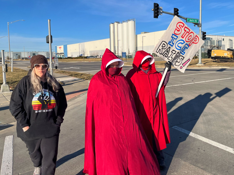 Protesters demonstrate outside a warehouse as federal officials tour it to consider repurposing it for an ICE detention facility in Kansas City