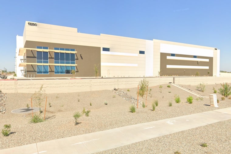 A Google street view screenshot shows a large, newly-built office industrial complex in a desert landscape.