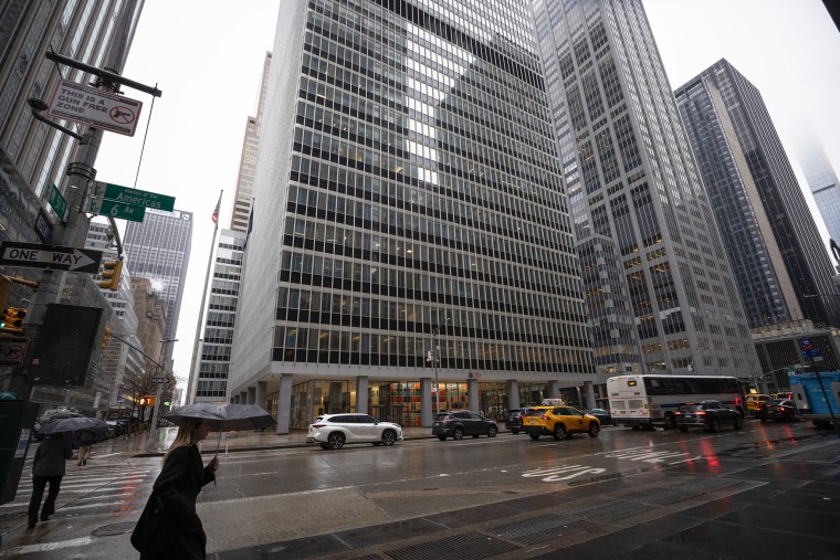 Manhattan skyscrapers seen from street level on a rainy day.