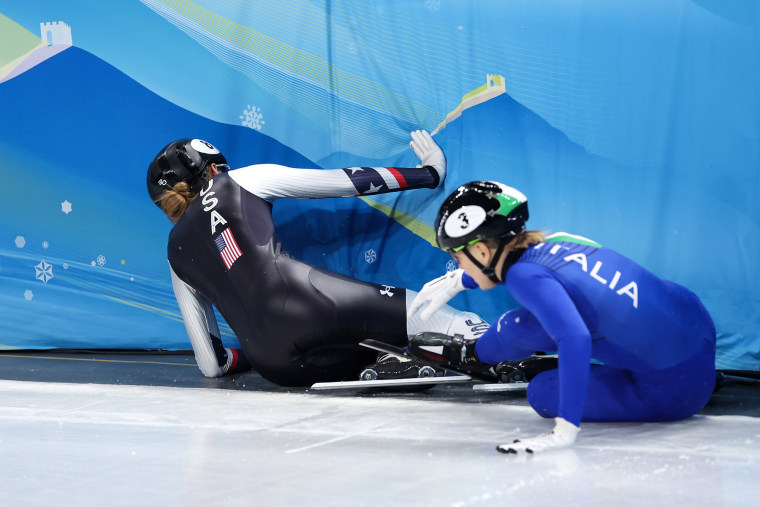 Kristen Santos, left, and Arianna Fontana crash into a wall while in a skating rink